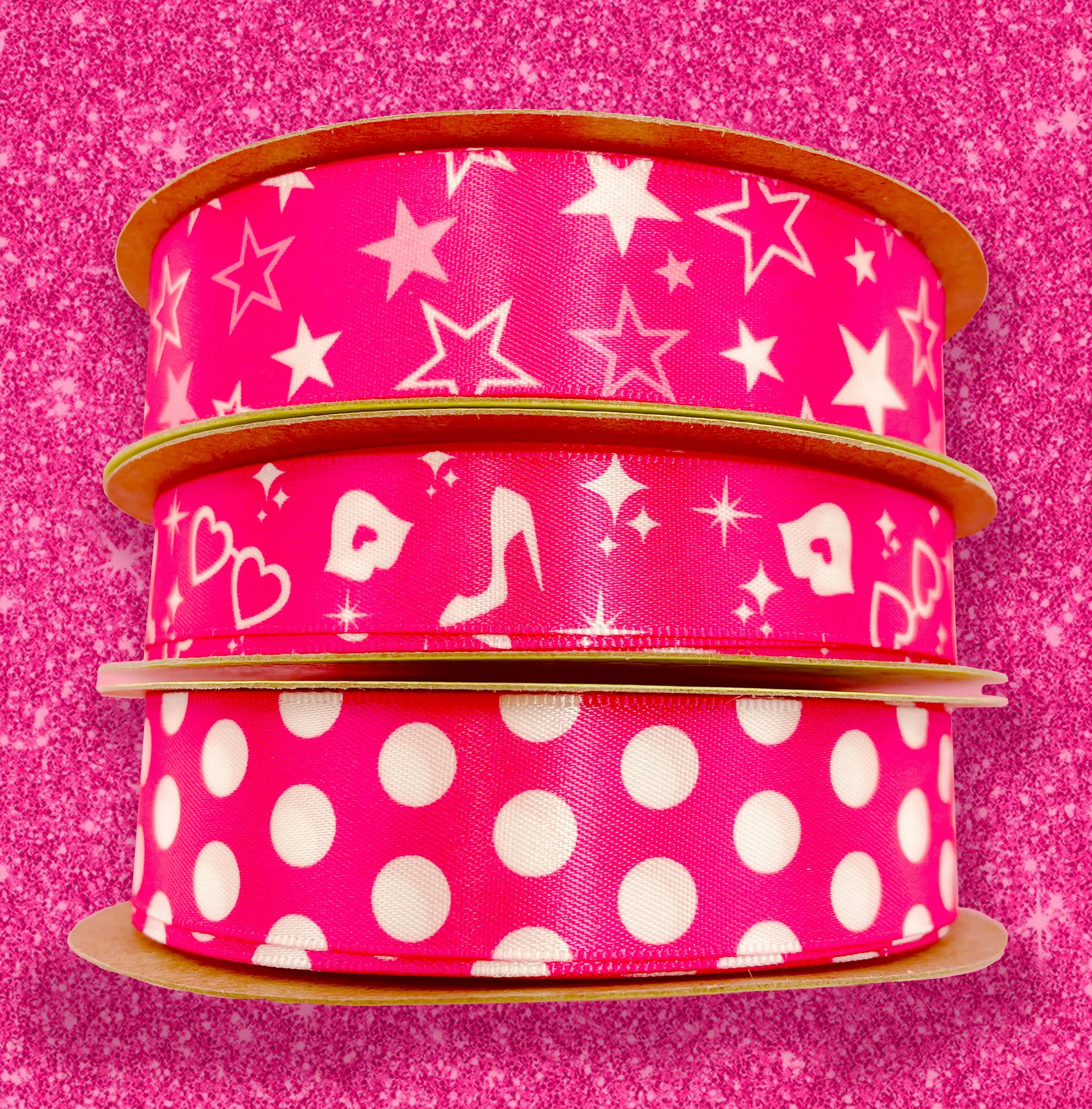 Hot pink ribbon Barbie inspired features shoes, hearts, lips and stars in white on a hot pink background printed on 5/8"white satin